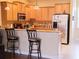 Open kitchen with granite countertops, stainless steel appliances, and plenty of cabinet space at 15387 Avenue Of The Arbors, Winter Garden, FL 34787