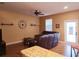 Comfortable living room featuring a plush leather sofa and hardwood flooring at 15387 Avenue Of The Arbors, Winter Garden, FL 34787