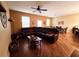 Spacious living room features stylish wood floors, modern fan, and comfortable seating at 15387 Avenue Of The Arbors, Winter Garden, FL 34787