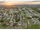 An aerial view shows the neighborhood with tree-lined streets in a well-planned layout at 25 Inconnu Dr, Kissimmee, FL 34759