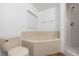 This bathroom has a corner tub, shower stall, toilet and small window at 25 Inconnu Dr, Kissimmee, FL 34759