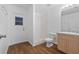 This bathroom includes wood-look flooring, a single sink vanity, toilet and shower area at 25 Inconnu Dr, Kissimmee, FL 34759