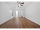 This bedroom features wood-look flooring and a view to the en-suite bathroom at 25 Inconnu Dr, Kissimmee, FL 34759