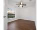 Cozy bedroom featuring vinyl flooring, a ceiling fan, and a large window for natural light at 25 Inconnu Dr, Kissimmee, FL 34759