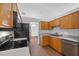 Functional kitchen featuring wood cabinets, and sleek stainless steel appliances at 25 Inconnu Dr, Kissimmee, FL 34759