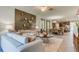 Open concept living room flows into the dining area, featuring stylish furnishings and decor at 4117 Jespersen St, Apopka, FL 32712