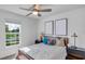 Comfortable bedroom with a cozy bed, two dark nightstands, and natural light from the window at 510 Puma Loop, Groveland, FL 34736