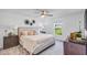 Inviting bedroom featuring a plush bed, side tables, and a scenic view from the window at 510 Puma Loop, Groveland, FL 34736