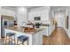 Bright kitchen featuring stainless steel appliances, a kitchen island with bar seating, and wood flooring at 510 Puma Loop, Groveland, FL 34736