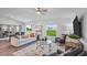 Bright living area featuring a comfortable sofa, a stylish rug, and large windows at 510 Puma Loop, Groveland, FL 34736