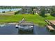 Lush backyard featuring a covered boat dock, grassy lawn, and view of the main house at 7769 Summerlake Pointe Blvd, Winter Garden, FL 34787