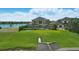 An aerial view captures the expansive backyard, lake frontage, and stunning residence at 7769 Summerlake Pointe Blvd, Winter Garden, FL 34787
