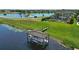 Scenic backyard view with covered boat dock, lawn and beautiful lakefront home at 7769 Summerlake Pointe Blvd, Winter Garden, FL 34787