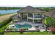 Outdoor living with a pool, lounge seating, and manicured landscaping, creating a private oasis at 7769 Summerlake Pointe Blvd, Winter Garden, FL 34787