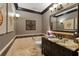 Stylish half-bathroom with a granite countertop, decorative mirror, and elegant lighting fixtures at 7769 Summerlake Pointe Blvd, Winter Garden, FL 34787
