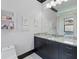 Well-lit bathroom features a granite countertop, large mirror, and updated fixtures at 7769 Summerlake Pointe Blvd, Winter Garden, FL 34787