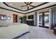 Spacious primary bedroom with large windows, walkout to covered patio, and stylish decor at 7769 Summerlake Pointe Blvd, Winter Garden, FL 34787
