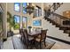 A formal dining room features a modern chandelier, staircase, and ample natural light at 7769 Summerlake Pointe Blvd, Winter Garden, FL 34787