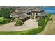 A luxurious estate boasts elegant stone accents, a circular driveway, and meticulously manicured landscaping at 7769 Summerlake Pointe Blvd, Winter Garden, FL 34787