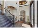 Grand foyer with dark hardwood flooring and an elegant staircase leading to a chandelier-lit upper level at 7769 Summerlake Pointe Blvd, Winter Garden, FL 34787