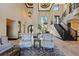 The foyer features soaring ceilings, a grand staircase, and ornate chandeliers, making a grand entrance at 7769 Summerlake Pointe Blvd, Winter Garden, FL 34787