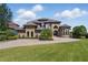 Expansive front yard with well-manicured lawn, landscaping, and a circular driveway at 7769 Summerlake Pointe Blvd, Winter Garden, FL 34787