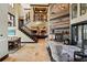 An open great room with a decorative fireplace, staircase, and views into the kitchen at 7769 Summerlake Pointe Blvd, Winter Garden, FL 34787