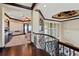 Hallway landing with wrought iron railing, dark hardwood floors, and coffered ceilings throughout at 7769 Summerlake Pointe Blvd, Winter Garden, FL 34787