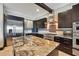 Gourmet kitchen with stainless steel appliances, granite counters, and custom cabinets, perfect for cooking and entertaining at 7769 Summerlake Pointe Blvd, Winter Garden, FL 34787