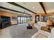 Spacious living area with comfortable seating, a large TV, and a view of the outdoor patio and lake, great for entertaining at 7769 Summerlake Pointe Blvd, Winter Garden, FL 34787