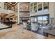 Spacious living area with high ceilings, a decorative fireplace, large windows, and elegant furnishings at 7769 Summerlake Pointe Blvd, Winter Garden, FL 34787