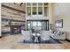 Comfortable living area with a stylish fireplace, large windows, and a sofa with lake views at 7769 Summerlake Pointe Blvd, Winter Garden, FL 34787