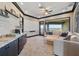 Spacious living room with a wet bar, plush carpeting, comfortable seating, and a beautiful water view at 7769 Summerlake Pointe Blvd, Winter Garden, FL 34787
