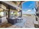 Inviting outdoor living space with plush seating, a fireplace, and views of the pool and waterfront at 7769 Summerlake Pointe Blvd, Winter Garden, FL 34787