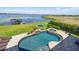 The backyard includes a pristine pool and spa overlooking a serene lake at 7769 Summerlake Pointe Blvd, Winter Garden, FL 34787