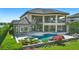 Back of house featuring a large pool and spa surrounded by lush landscaping and a covered patio, great for entertaining at 7769 Summerlake Pointe Blvd, Winter Garden, FL 34787