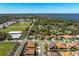 Aerial view showcases the home near a lake and athletic fields, surrounded by mature trees at 108 Stanton Estates Cir, Winter Garden, FL 34787