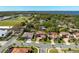 Aerial view of a beautiful property near the lake, highlighted by manicured lawns and a barrel tile roof at 108 Stanton Estates Cir, Winter Garden, FL 34787