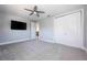 Comfortable bedroom with plush carpeting, TV, ceiling fan, neutral tones, and ample closet space at 108 Stanton Estates Cir, Winter Garden, FL 34787