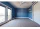 Blue bedroom with carpet flooring and balcony featuring a fan and closet space at 108 Stanton Estates Cir, Winter Garden, FL 34787