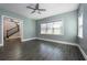 Light and airy bedroom featuring wood-look tile flooring and staircase access at 108 Stanton Estates Cir, Winter Garden, FL 34787