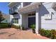 Inviting front entrance with double doors, brick pavers, and manicured landscaping at 108 Stanton Estates Cir, Winter Garden, FL 34787