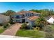 Stunning two-story home featuring a barrel tile roof, paved driveway, and lush landscaping at 108 Stanton Estates Cir, Winter Garden, FL 34787