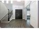 Grand foyer with dark wood double doors, staircase, and wood-look tile flooring at 108 Stanton Estates Cir, Winter Garden, FL 34787