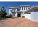 Stunning home featuring a balcony, a three car garage and a basketball hoop over a brick driveway at 108 Stanton Estates Cir, Winter Garden, FL 34787