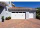 Three-car garage with brick paver driveway at 108 Stanton Estates Cir, Winter Garden, FL 34787