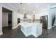 Bright open kitchen with stainless steel appliances, a large center island and modern pendant lighting at 108 Stanton Estates Cir, Winter Garden, FL 34787