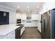 Bright kitchen featuring stainless steel appliances, a large island, and sleek white cabinetry at 108 Stanton Estates Cir, Winter Garden, FL 34787