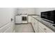 Well-equipped laundry room with granite counters, modern appliances, and ample cabinet space at 108 Stanton Estates Cir, Winter Garden, FL 34787