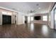 Expansive living room with wood-look floors, a modern ceiling fan, and a large TV at 108 Stanton Estates Cir, Winter Garden, FL 34787